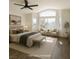Staged main bedroom with many windows, a ceiling fan, a king bed, and seating at 912 Pro Players Dr, Las Vegas, NV 89134