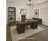 This staged office features a wooden desk, chair, and shelving with natural light, creating a productive workspace at 912 Pro Players Dr, Las Vegas, NV 89134