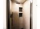 This modern shower showcases a rainfall showerhead and tiled niche, offering a spa-like experience at 912 Pro Players Dr, Las Vegas, NV 89134
