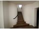 A curved staircase with wooden steps and a sleek black handrail, blending style with functionality at 912 Pro Players Dr, Las Vegas, NV 89134
