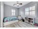 Bright bedroom with natural light, wood-look flooring, a ceiling fan, and simple, yet stylish, decor at 9349 Olympia Falls Ave, Las Vegas, NV 89149