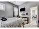Bedroom features TV, bed and small window at 9349 Olympia Falls Ave, Las Vegas, NV 89149