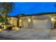 Well-maintained home featuring a spacious driveway, a two-car garage, manicured landscaping, and inviting curb appeal at 9349 Olympia Falls Ave, Las Vegas, NV 89149