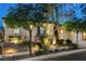 Charming home with a beautifully landscaped front yard, mature trees, and inviting curb appeal at 9349 Olympia Falls Ave, Las Vegas, NV 89149