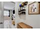 Hallway with decorative display shelves leading into living area with TV and fireplace at 9349 Olympia Falls Ave, Las Vegas, NV 89149