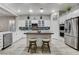 Stylish kitchen with stainless steel appliances, white cabinets, and a central island with seating at 9349 Olympia Falls Ave, Las Vegas, NV 89149