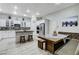 Modern kitchen with white cabinets, stainless steel appliances, kitchen island and breakfast nook with bench seating at 9349 Olympia Falls Ave, Las Vegas, NV 89149