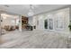 Spacious living area with wood-look floors that open to a comfortable seating area at 9349 Olympia Falls Ave, Las Vegas, NV 89149