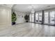 Bright living area with wood-look flooring, access to the backyard, and ample space at 9349 Olympia Falls Ave, Las Vegas, NV 89149