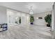 Open-concept living space with stylish wood flooring, shutters, and ample natural light at 9349 Olympia Falls Ave, Las Vegas, NV 89149
