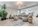 Open-concept living room with a comfortable grey sectional and wood-look flooring at 9349 Olympia Falls Ave, Las Vegas, NV 89149