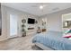 Light-filled main bedroom boasts modern decor, fireplace, and an ensuite bathroom at 9349 Olympia Falls Ave, Las Vegas, NV 89149
