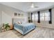 Main bedroom showcasing a plush bed frame, wood-look floors, and lots of light at 9349 Olympia Falls Ave, Las Vegas, NV 89149