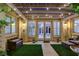 Charming outdoor patio has a pergola, string lights, stone flooring, and cozy seating for relaxing at 9349 Olympia Falls Ave, Las Vegas, NV 89149