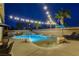 Resort-style pool area with palm trees, rock features, and inviting lounge chairs for ultimate relaxation at 9349 Olympia Falls Ave, Las Vegas, NV 89149