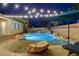 Backyard pool has a spa, umbrella, and mature palm trees, ideal for outdoor enjoyment at 9349 Olympia Falls Ave, Las Vegas, NV 89149