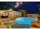 Pool with a spa, rock features, and umbrellas creates a relaxing outdoor retreat at 9349 Olympia Falls Ave, Las Vegas, NV 89149