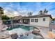 A stunning backyard pool with a spa, rock features, patio, and outdoor seating for relaxation and entertainment at 9349 Olympia Falls Ave, Las Vegas, NV 89149