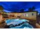 Sparkling pool features a spa, lush landscaping, and string lights for evening enjoyment at 9349 Olympia Falls Ave, Las Vegas, NV 89149
