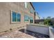 A cozy backyard features low wall, small plants, patio and partial home view at 9564 Archer Peak Ct, Las Vegas, NV 89143