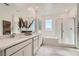 This bright primary bath offers double sinks, soaking tub, and walk-in shower at 9564 Archer Peak Ct, Las Vegas, NV 89143