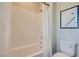 Bright bathroom with a shower and bathtub combo and sleek white tiling at 9564 Archer Peak Ct, Las Vegas, NV 89143