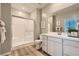 Bathroom featuring a glass-enclosed shower and double sink vanity with modern fixtures at 9564 Archer Peak Ct, Las Vegas, NV 89143
