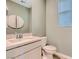 Powder room features a white vanity with quartz countertop and decorative wall art at 9564 Archer Peak Ct, Las Vegas, NV 89143