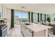 Modern kitchen with stainless steel appliances, quartz countertops, and an adjacent dining area, perfect for cooking at 9564 Archer Peak Ct, Las Vegas, NV 89143