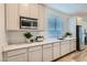Kitchen with stainless steel appliances, white cabinets, and white marble countertops at 9564 Archer Peak Ct, Las Vegas, NV 89143