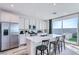 Bright kitchen features a large center island with bar seating and sliding doors that lead to an outdoor area at 9564 Archer Peak Ct, Las Vegas, NV 89143