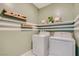 Laundry room with side-by-side washer and dryer and decorative wall accents at 9564 Archer Peak Ct, Las Vegas, NV 89143