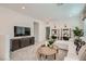 Cozy living room with modern furniture, TV, work space, and neutral color palette at 9564 Archer Peak Ct, Las Vegas, NV 89143