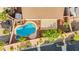 Backyard aerial view of home with pool, hot tub, patio, and low-maintenance landscaping at 977 Courtney Valley St, Henderson, NV 89052