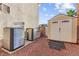 Functional backyard featuring air conditioning units, shed, and storage, optimizing space and utility at 977 Courtney Valley St, Henderson, NV 89052