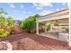 Covered patio with ceiling fans, overlooking backyard landscaping and pool at 977 Courtney Valley St, Henderson, NV 89052