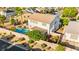 An aerial view of a backyard featuring a sparkling blue pool, mature landscaping, and privacy wall, ideal for outdoor living at 977 Courtney Valley St, Henderson, NV 89052