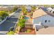 An aerial view of a backyard featuring a sparkling blue pool, mature landscaping, and covered patio, perfect for entertaining at 977 Courtney Valley St, Henderson, NV 89052