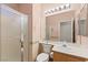 A bathroom featuring a large mirror, shower stall and a single sink vanity at 977 Courtney Valley St, Henderson, NV 89052