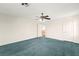 Large bedroom with blue carpets and two doors and a window at 977 Courtney Valley St, Henderson, NV 89052