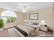 This staged bedroom features decor, ample light, and a fan at 977 Courtney Valley St, Henderson, NV 89052