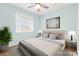 Bright bedroom featuring a ceiling fan, window with blinds, neutral color palette, and stylish decor at 977 Courtney Valley St, Henderson, NV 89052