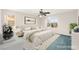 Staged bedroom with a large bed, ceiling fan, and view of the outside at 977 Courtney Valley St, Henderson, NV 89052