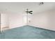 Spacious bedroom with light walls, blue carpet, ceiling fan, and closet at 977 Courtney Valley St, Henderson, NV 89052