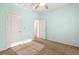 A basic bedroom with ceiling fan, carpet, light-green walls and white doors at 977 Courtney Valley St, Henderson, NV 89052