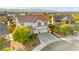 Well-maintained two-story home with mature trees, a three-car garage, and a welcoming front porch in a Gathering-friendly neighborhood at 977 Courtney Valley St, Henderson, NV 89052