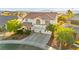 Charming two-story home with a well-manicured lawn, three-car garage, and inviting curb appeal at 977 Courtney Valley St, Henderson, NV 89052