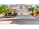 Charming two-story home with a well-manicured front yard and attached two-car garage at 977 Courtney Valley St, Henderson, NV 89052
