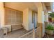 Inviting front porch sitting area with bench and decorative planters at 977 Courtney Valley St, Henderson, NV 89052