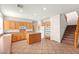 Kitchen with tile floor, wood cabinets, an island, and stainless steel appliances at 977 Courtney Valley St, Henderson, NV 89052